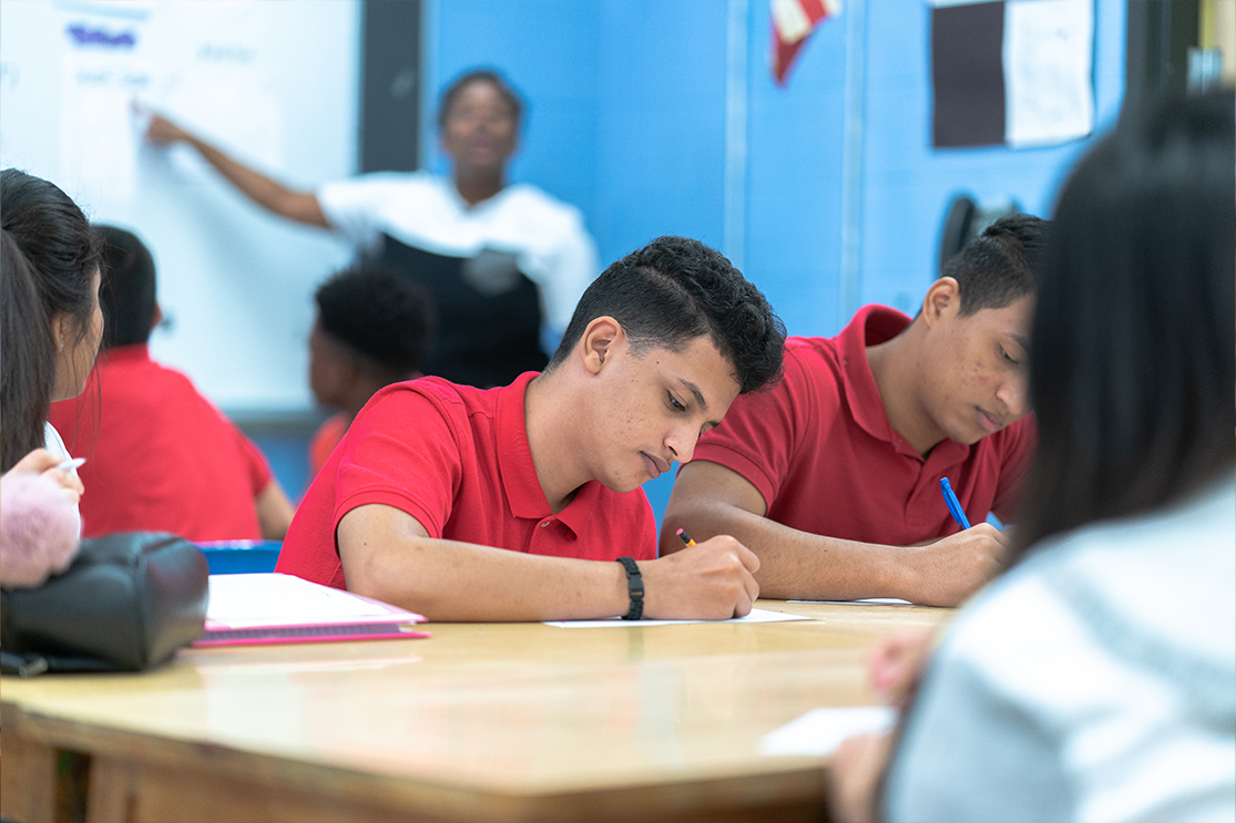 Two HS Students Writing in Classroom